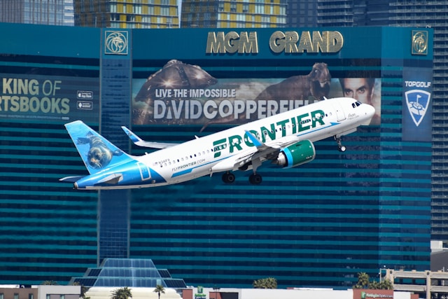 A image of a plane taking off in Las Vegas with the MGM Grand in the background.