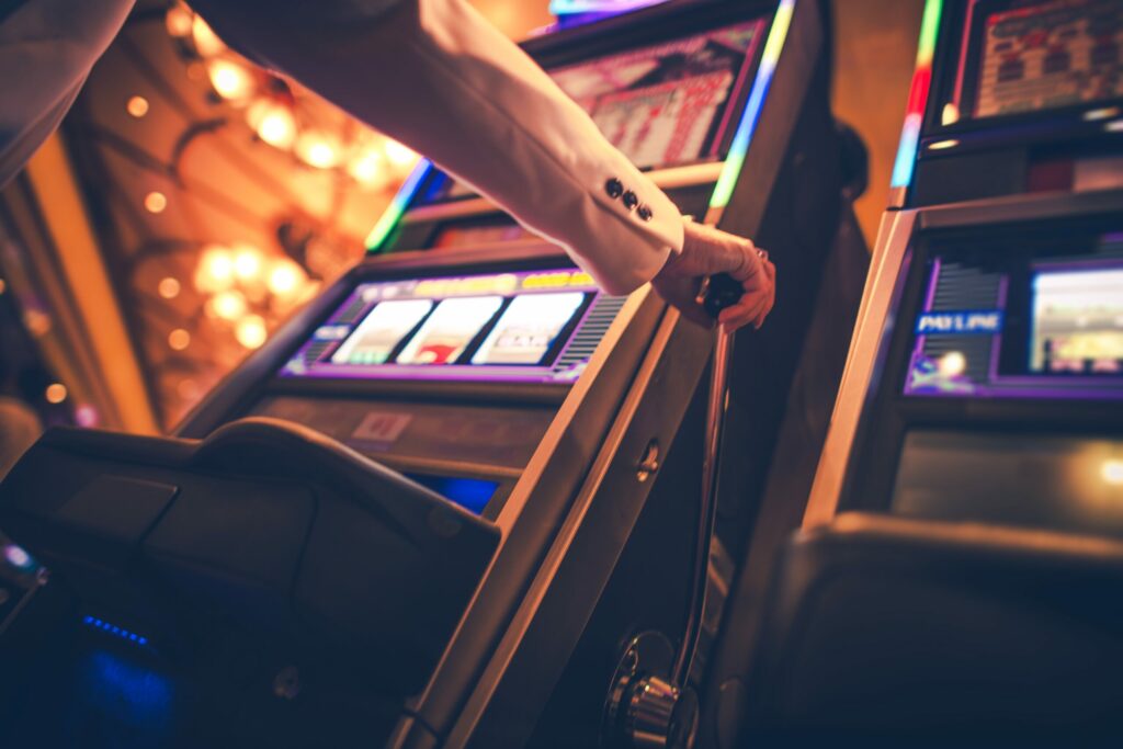 A photo of someone pulled a slot machine lever in a casino.