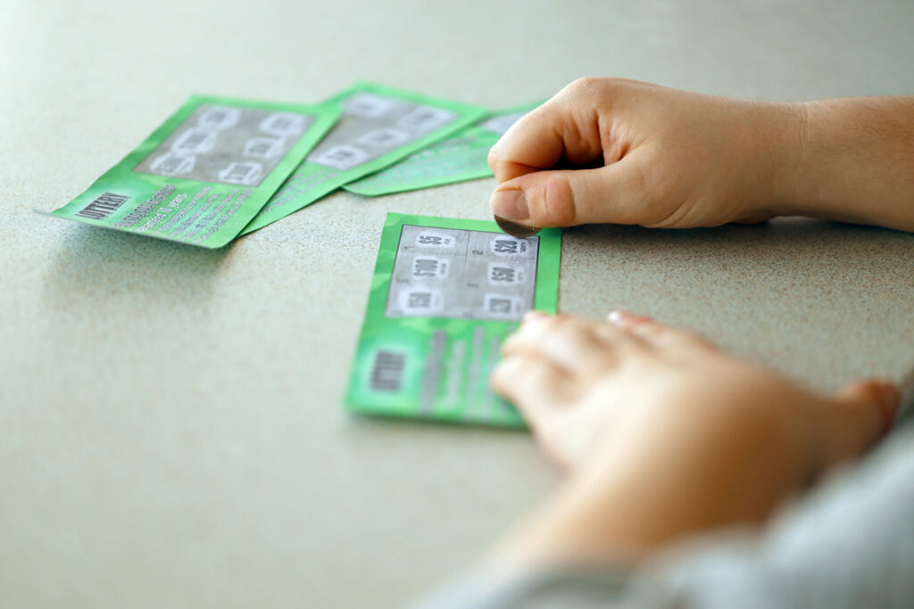 A photo of a person scratching off a scratch card.