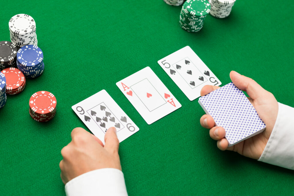 A photo of a person playing 3 Card Poker.