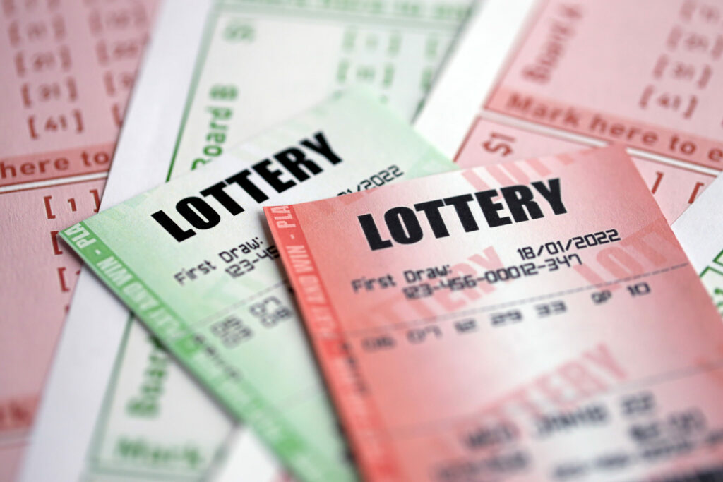 A close up photo of a green and red lottery ticket.