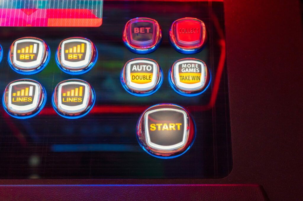 A close up photo of several buttons on a slot machine.