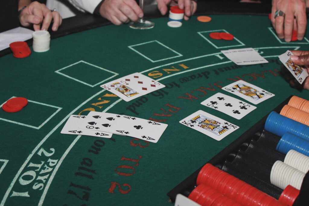 A photo of playing cards and casino chips during a game of blackjack.
