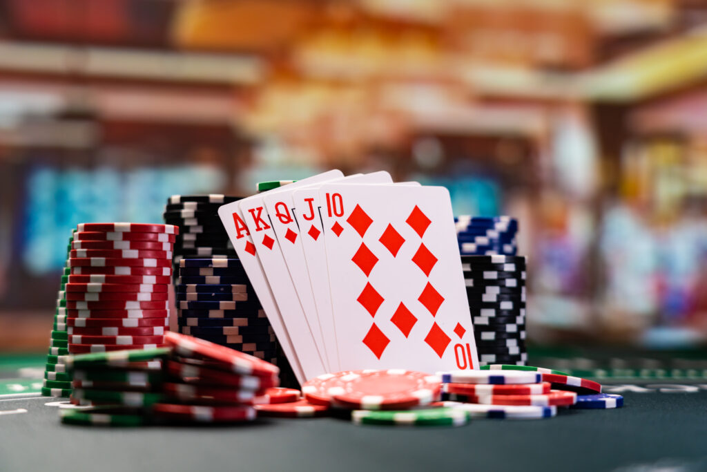 A photo of playing cards and casino chips in a casino.