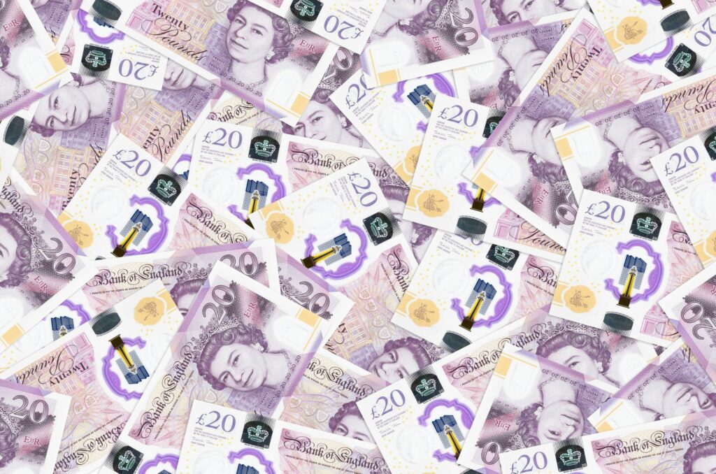 A photo of a pile of twenty pound notes.