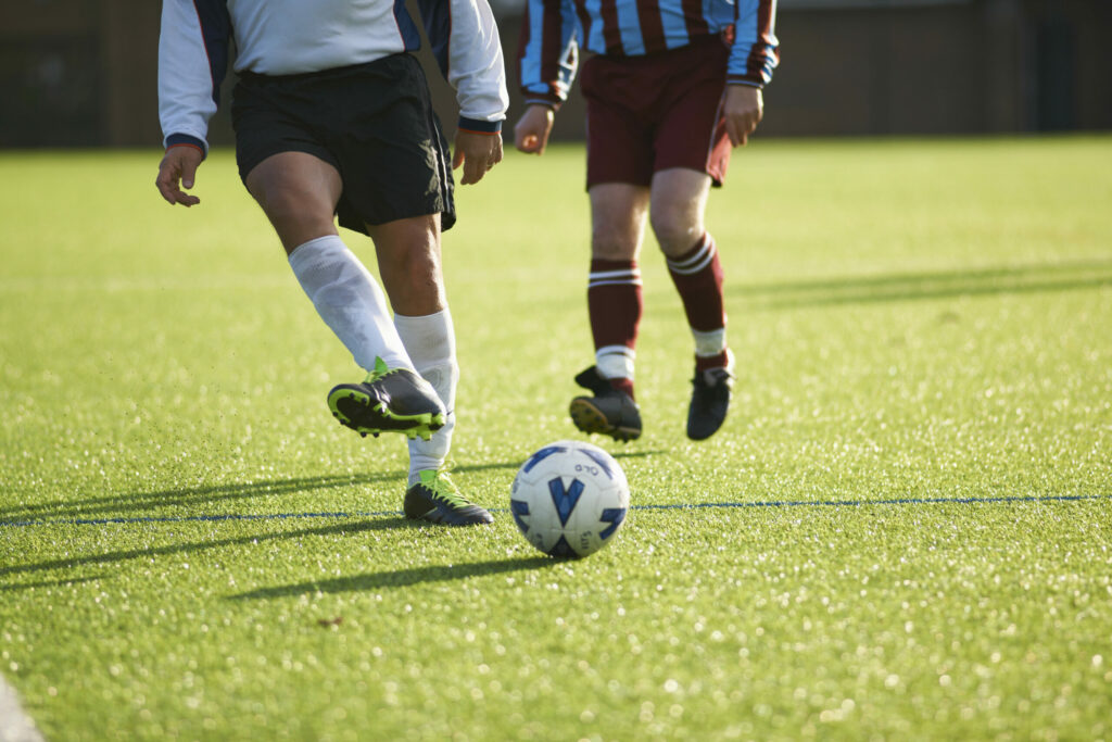A photo of two players playing during a football match.