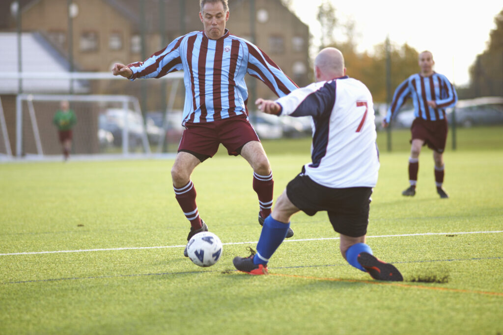 A photo of two players going for the ball during a match.