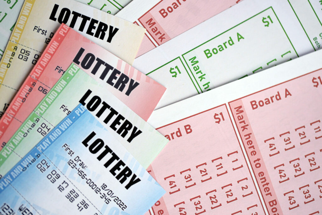 A photo of lottery tickets of different colours.