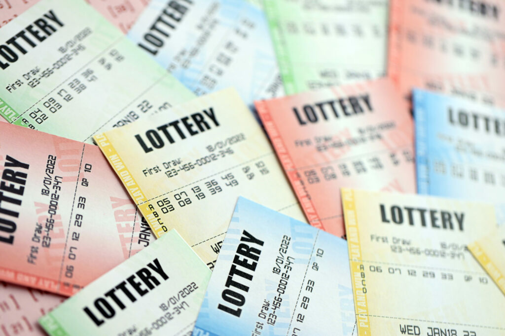 A close up photo of multiple lottery tickets of different colours.