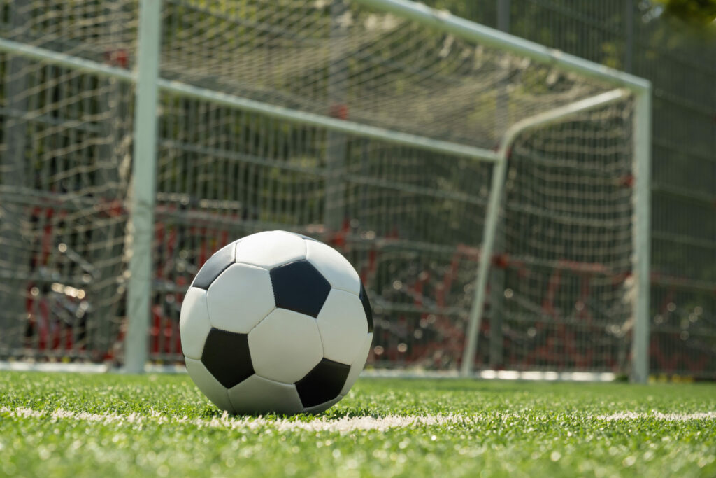 A photo of a football in front of a goal.