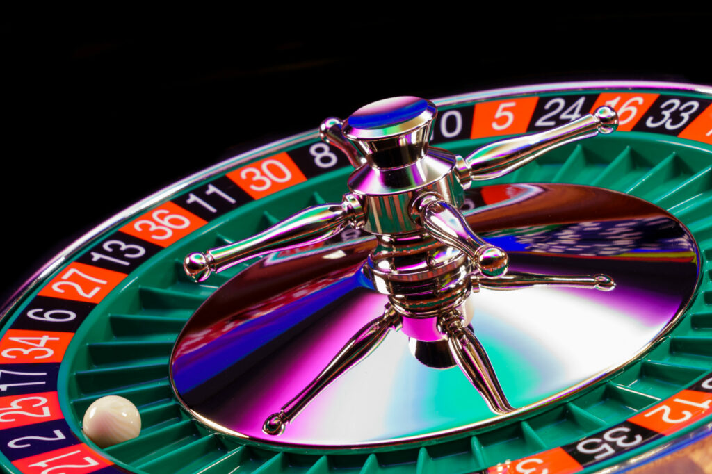 Roulette wheel close up isolated on black background with white ball on 2.