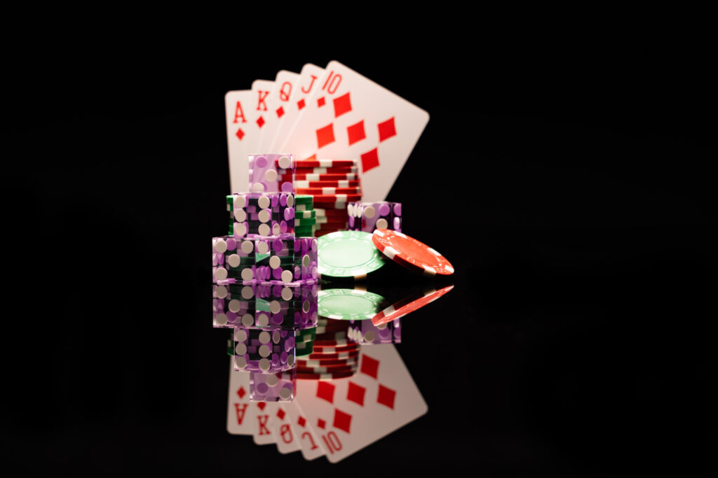 Play cards, casino chips and dice on a black background.