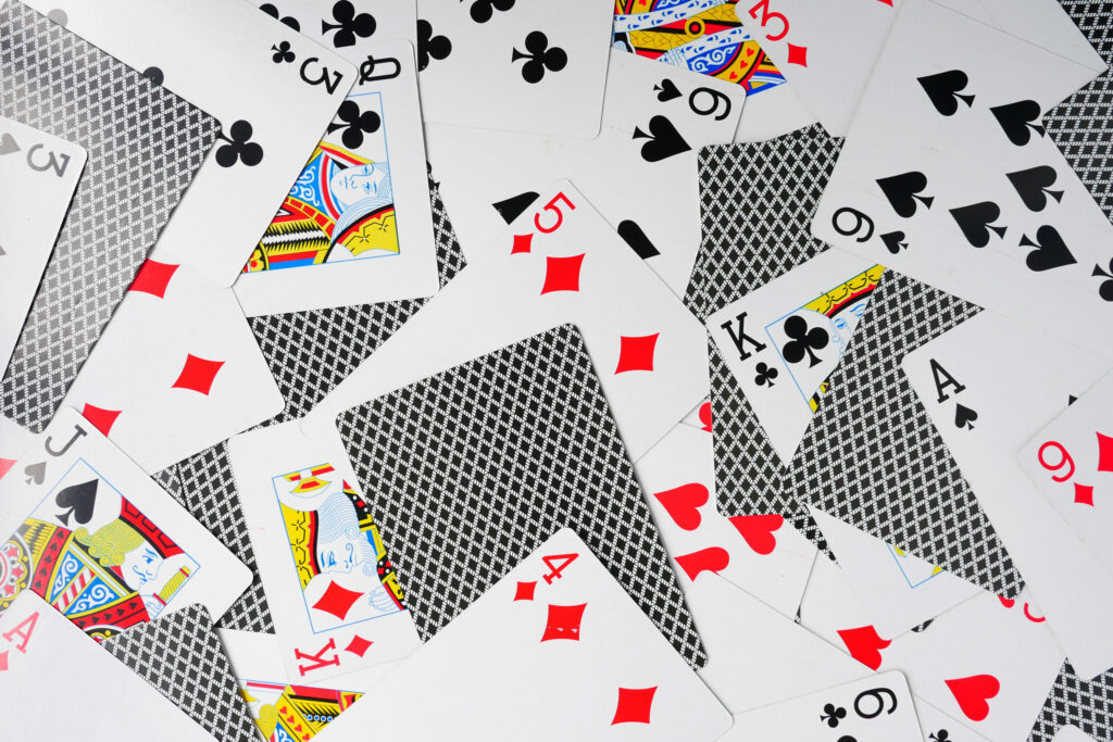 Playing cards spread across a flat surface.