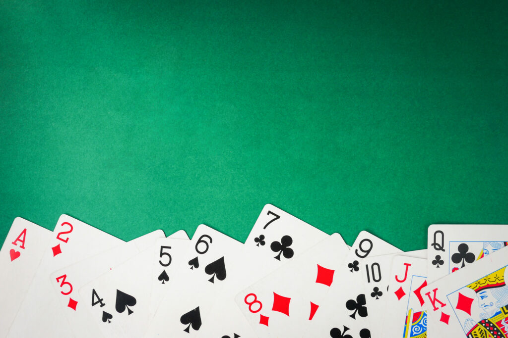 Playing cards on a green background.