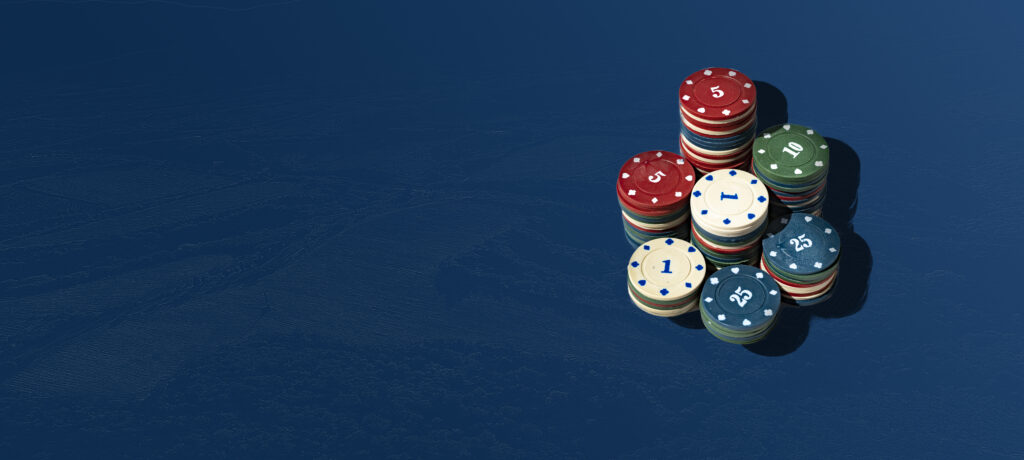 Seven piles of casino chips on a blue background.