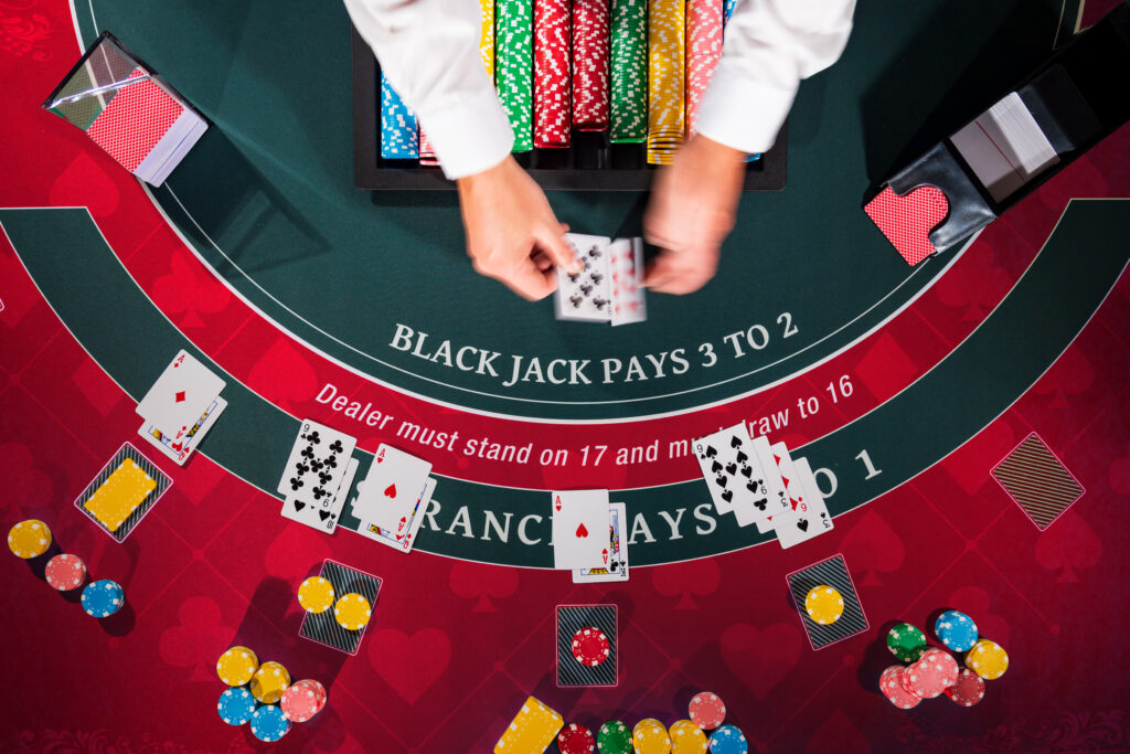 Overhead view with dealer hands of a casino blackjack table.