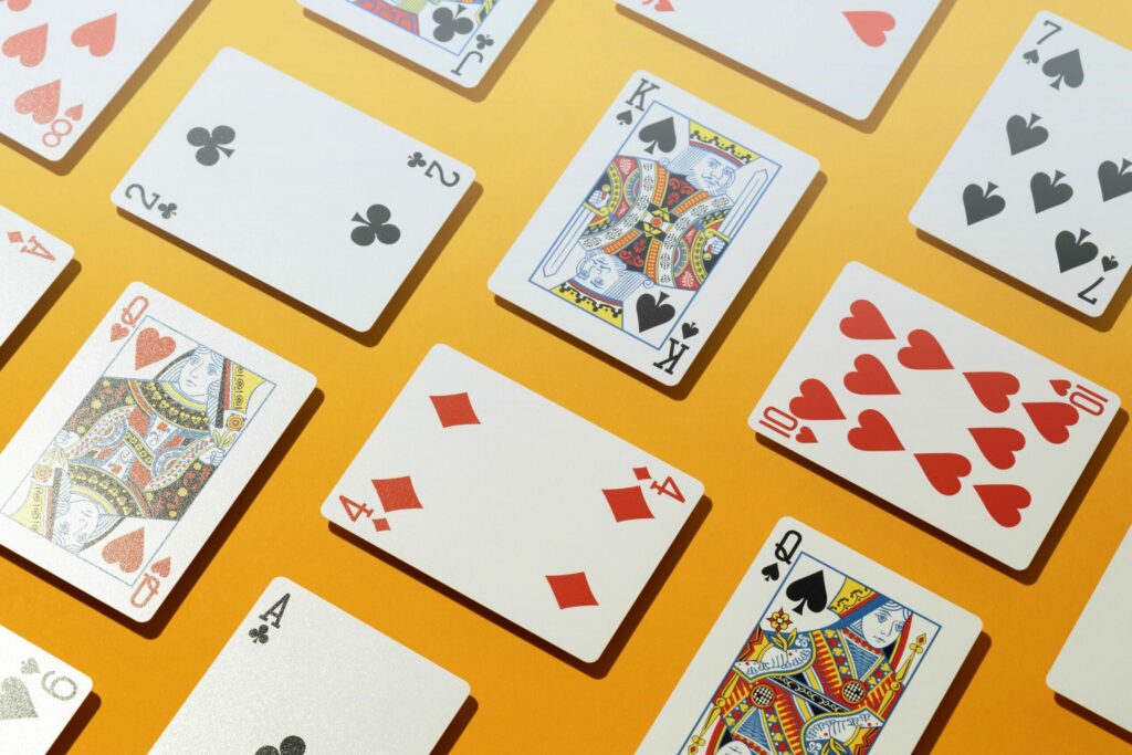 A close-up shot of a group of casino cards on a yellow background.