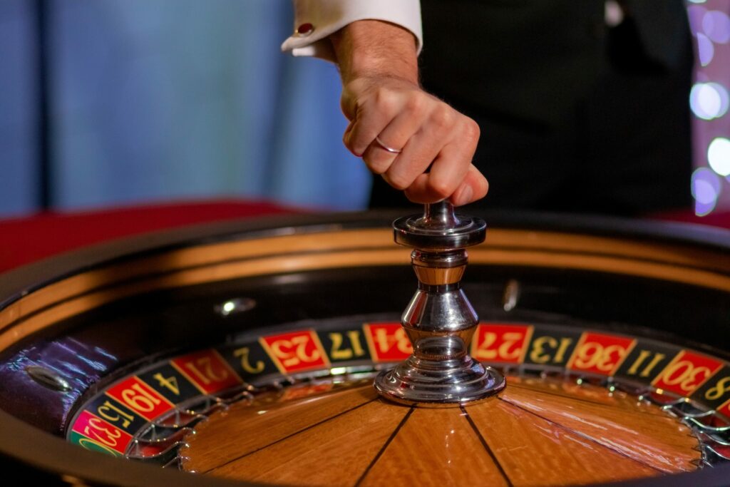 Croupier about to spin a roulette wheel.