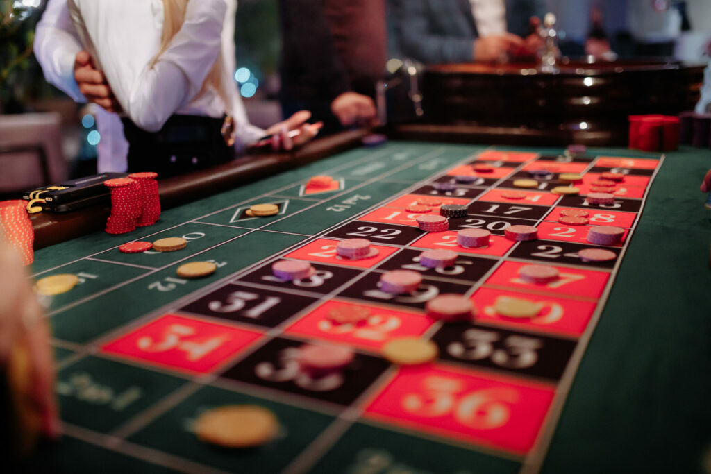 Casino chips on a roulette table's racetrack.