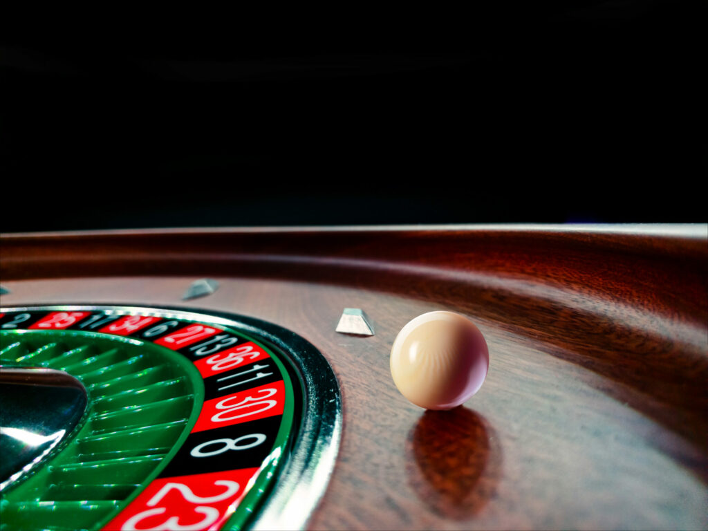 Roulette wheel with ball on edge.
