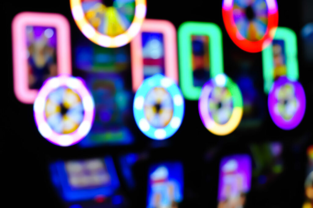 Modern slot machines in a casino. Machines are out of focus.