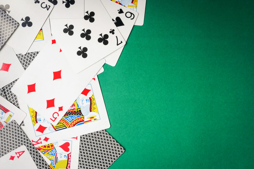 Playing cards on a green table.